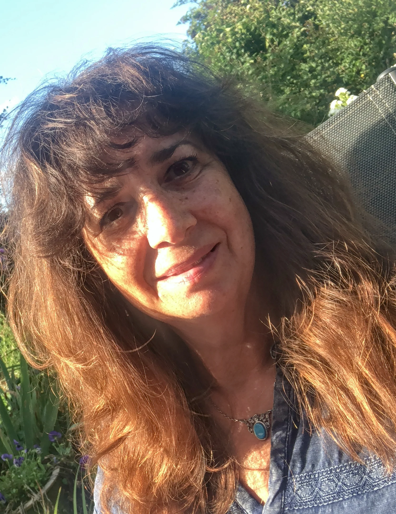 Angela Jackson-Grillet from Skylark Consultants on beach with camera